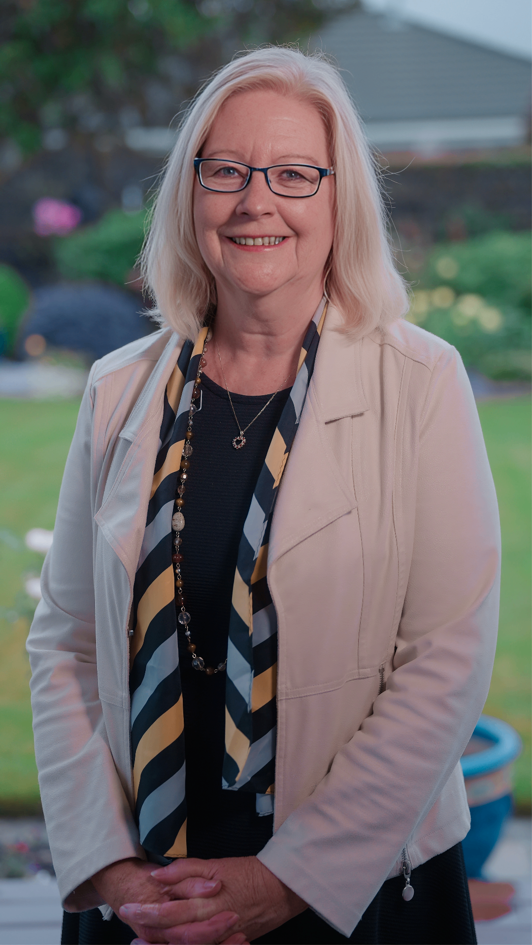 Donna smiling in a light jacket
